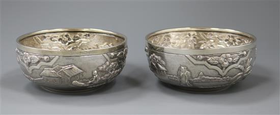 A pair of Indian embossed white metal bowls, 11cm.
